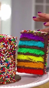 Delicious Rainbow Cake - The Cake Boss' most colorful creation!🌈🎂 What are you waiting for? Order our famous Rainbow Cake creation which is six layers of happiness wrapped in a sweet vanilla buttercream frosting and then engulfed in rainbow sprinkles. | Carlo's Bakery