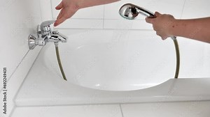 water consumption.Water procedures in the bath and shower. Hot water from the shower head pours onto your hand and into the bathtub.water for washing. 4k footage