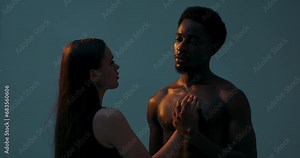 African american black dark skinned man and white woman observing each other trying to know. Serious concentrated african man holding the female's hand on chest. Multinational couple. Body positive.
