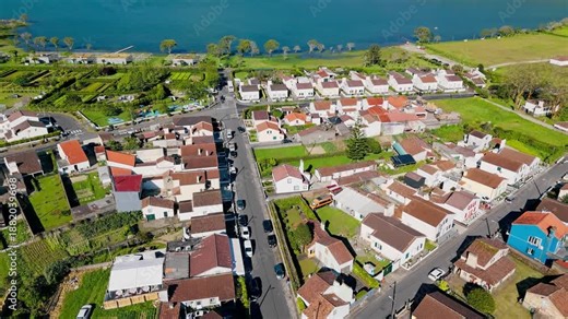 Aerial view of Sete Cidades village by crater lake with green hills on Sao Miguel, Azores