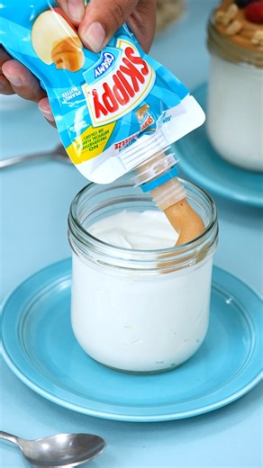 Breakfast on the go? SKIPPY® Peanut Butter Squeeze Pack is your new best friend! Add a delicious drizzle of SKIPPY® Peanut Butter to your yogurt parfait for a peanut buttery twist - perfect for wherever your morning takes you. | SKIPPY Peanut Butter