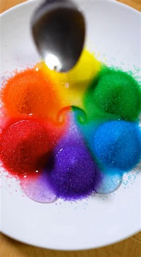 🌈💥 Rainbow Sugar Crystal Volcano Burst This striking crystal volcano effect is made using basic kitchen ingredients. A warm sugar solution saturates dry sugar, and when baking soda meets vinegar, the reaction creates rapid expansion and colorful foamy mounds that dry into textured crystal formations. Here is the complete process. 🧪 Materials • Granulated sugar • Very hot water • Food coloring (multiple colors) • Baking soda • White vinegar • Small cups • Spoons • A shallow plate Step 1: Form 