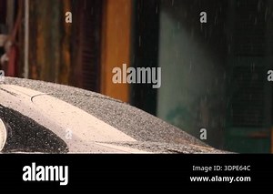 blurred traffic view through a car windscreen covered in rain for background