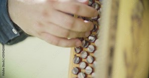 Close up slow motion shot man playing on accordion, musician hands.