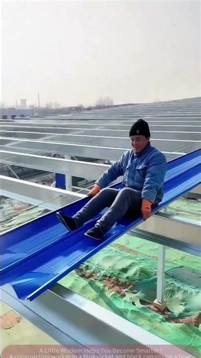 Fun Moments: Worker Sliding Down Metal Roof Panels