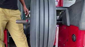 Computer wheel balancing on special machine, Wheel balancing close up, Auto mechanic balances the car wheel on the wheel balancer Stock Video