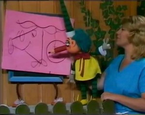 Do you remember Mr Squiggle, Miss Jane and Blackboard? Mr Squiggle insisted that Miss Jane hold his hand and Blackboard was always “Hurry Up!” Kids would send in a squiggle which Mr Squiggle would cleverly turn into a picture with his pencil nose, but he would draw the picture upside down or sideways. “Upside down Miss Jane. Upside down.” The popular ABC show was created by Norman Hetherington and ran from 1959 - 1999. Hetherington, voiced and operated all of the show's puppets, while his wife M