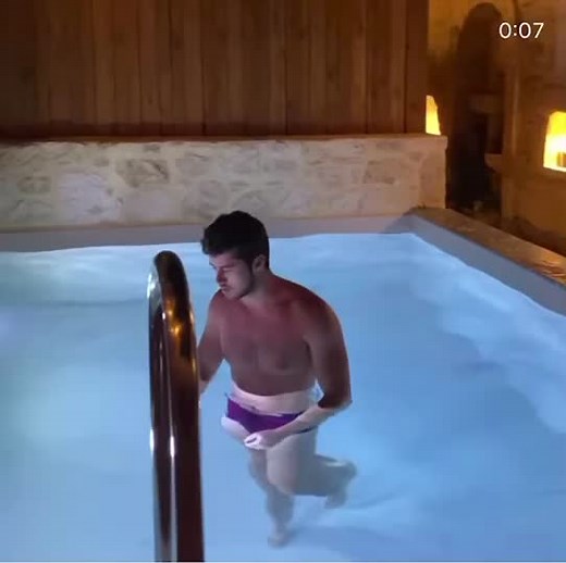 Indoor Pool Fitness Routine by a Male Model
