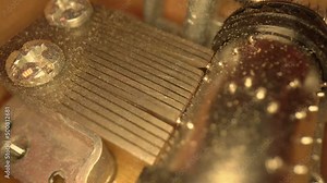 Musical box inside mechanism close up. Music box drum clockwork mechanism close up on turning barrel and cogs. Old music box mechanism, rotating cylinder closeup