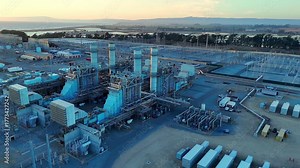 Natural gas power generation plant at Moss Landing viewed from above at dusk in conjunction with grid scale battery storage