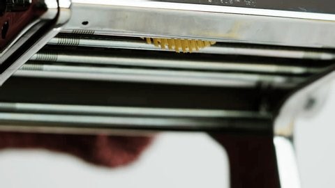 clip-4016421241-woman-using-pasta-machine-make-fresh-dough