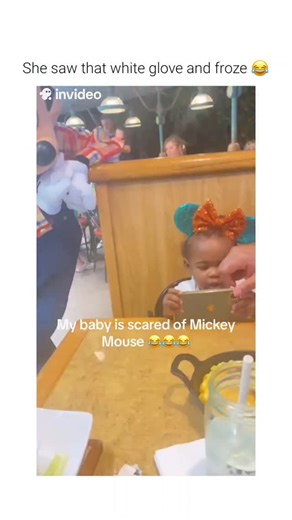 ILL HUMORS on Instagram: "This video captures a common developmental response in young children known as "costume character fear." ​The Subject A toddler sitting at a restaurant table reacts with increasing apprehension as a person in a full-body Mickey Mouse costume approaches. Despite wearing themed ears, the child exhibits avoidant behavior before eventually crying. ​The Mechanism This reaction is often triggered by a "category error" in a child's developing brain. While they recognize the ch