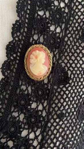Beautiful vintage cameo brooch!🧡 Seems hand poured, and a lovely color combination of coral and ivory!✨ Measures 1 3/8” x 1”. Framed in a gold-tone rope border with her original rolling clasp, she’s ready to elevate any cardigan, blouse, coat lapel, or hat! $28 #vintagebrooch #cameobrooch #vintagecameo #1960svintage #1970svintage #victorianrevival #vintagejewelry #vintagecollector #midcenturyjewelry #broochcollector #retrostyle #vintageseller #etsyseller #vintagestyle #antiquesandvintage #heirl