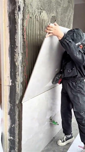 Installing a large ceramic tile on a wall with adhesive #shorts