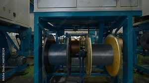 Rotating coils in industrial enterprise. Creative. Process of plastic alloy and winding of polymer rods. Chemical workshop of industrial plant