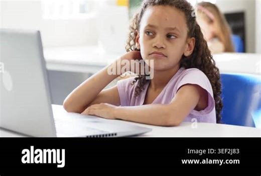 Female child student noticing blurred classmate, shifting gaze and rubbing ear at desk with laptop. Classroom, bored, disengaged, computer, daylight, chair, pastel Stock Video Footage - Alamy