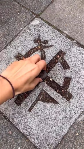 Geocaching on Instagram: "🚶 Would you notice this geocache walking down the street? 🚶 Disclaimer: Buried caches MUST have permission from the property owner. Video: geheimpunkt.de. Video: Two geocachers walk on the sidewalk and stop in front of a paver with the geocaching logo. In the center of the logo is a metal piece. One of the geocachers steps on the middle piece, bends down, and pulls on it, revealing a geocache container attached below. They hold the container up to the camera and then 