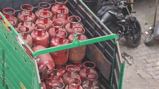 Dedicated laborers upload LPG cylinders to a truck for efficient doorstep delivery, ensuring energy access in urban areas.