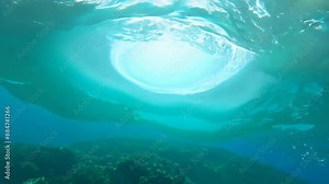 Mesmerizing underwater vortex spins through turquoise waters. Bright center creates hypnotic portal effect, inviting exploration of vast ocean beyond.