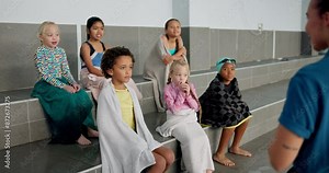 Teaching, kids and lessons for swimming, swimwear and smile for learning, bench and listen to teacher. Swimmer, boys and girls in group for fun in middle school, explanation and rules of pool