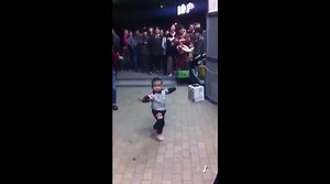Dancing toddler leads whole troupe of dancers in Chinese square