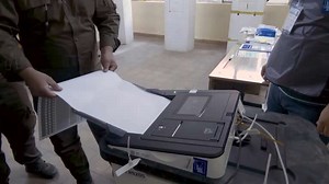 Iraqi security forces cast votes before polls open to the public