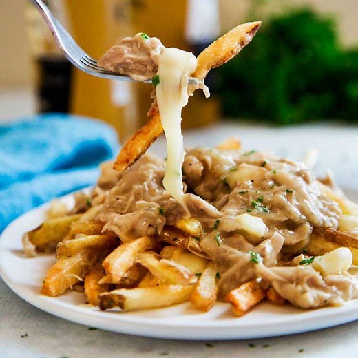 3.6K views · 78 reactions | This poutine recipe features crispy french fries smothered with rich gravy, seasoned shredded chicken, and cheese curds. Make this Canadian comfort food for dinner; it’s delicious! https://keviniscooking.com/the-ultimate-chicken-poutine/ | Kevin Is Cooking | Facebook