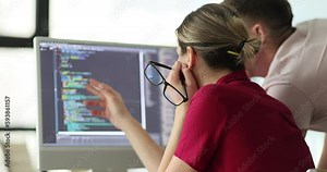 Software developers discussing compiling source code and discovering bugs. Team executing algorithms and programmers working in team