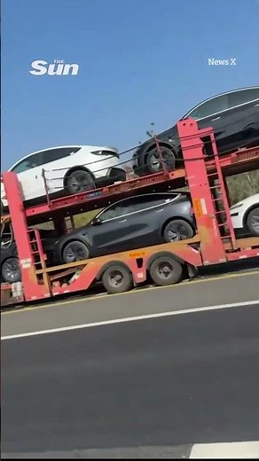 Shocking moment lorry carrying new Tesla EV cars mysteriously bursts into flames on busy motorway
