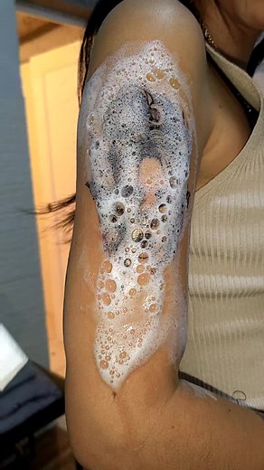Intricate Tattoo Cleaning Process on Upper Arm