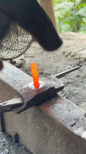 Beating blazing metal rods to yield heavy rivets