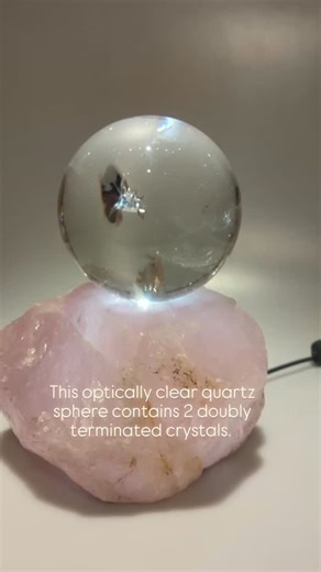 Manifestation x 2! This optically clear quartz crystal sphere contains two doubly terminated free-floating crystals. This kind of formation is called a manifestation Crystal. In order for this rare occurrence to happen the doubly terminated crystals have to form first in a gravity free environment and then be encapsulated by a larger Crystal. The rose quartz light base was created by artist Hovave Rappaport @hovaveart . It is engraved with symbols of divine masculine and feminine energy. The sph