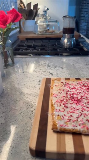 Giant Strawberry Pop-Tart 🍓 💕 Ingredients: • 1 pack (2 crusts) pre-made pie crusts • 1 cup strawberry preserves • 1 cup powdered sugar • 1 1/2 tablespoons milk • 2 tablespoons melted butter • Sprinkles (optional) Instructions: 1. Preheat oven to 375°F. Roll out pie crusts into a large rectangle and cut to fit your baking pan. 2. Place one crust on a parchment-lined baking sheet. Spread preserves evenly, leaving a 1-inch border. 3. Lay the second crust on top, press edges to seal, and crimp wit