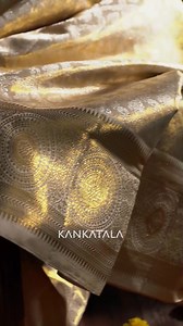 This Kanchipuram Silk Tissue Gold Saree with criss cross checks and butta delightfully radiating in the metallic hues of gold is woven to brighten up your bridal couture. Dripping elegance, the gold tissue base is embodied with gold zari tissue with silver zari criss cross checks checks and floral butta. The self-gold zari medium border features floral chakras and temples. The self-gold zari brocade Pallu convoyed by elephant motifs in floral vines, exudes grandeur. At Kankatala, we have investe
