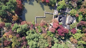 High angle view of beautiful landscape of Tianpin mountain park in Suzhou, Jiangsu, China. Red maple trees, yellow ginkgo trees, traditional Chinese garden buildings. 4K real time footage drone view.