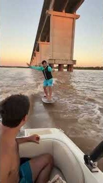 Thrilling Hydrofoil Ride Under a Bridge at Sunset