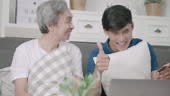 Video Scene of Son and Dad helping each other for online shopping...