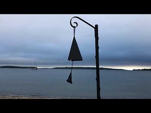 Boothbay Harbor Buoy Bell on the beach in Maine at dawn