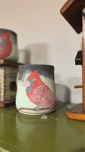 Karina Aimee Kudla on Instagram: "Cardinals… these little bright red birds inspired me after landing on the fence by the bamboo in the studio backyard. I love watching the birds flying by while creating something special @aimeeshandcrafts Here there are two cardinals. I always like drawing them in different positions. #redcarnilal #cardinal #cardinalbird #natureinspired #potterylovers #handmadeceramics #handmadepots #ceramicpot #handthrown #supportlocal #claylife #handmadeceramics #aimeeshandcra
