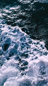 A view of the ocean from above with waves