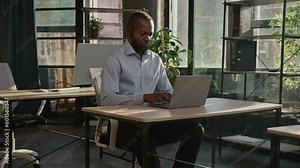 African american mature businessman working business project typing email on laptop in sunny office pensive focused man male entrepreneur middle-aged ethnic employer programming on computer keyboard