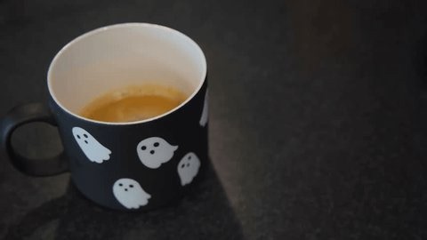clip-4196241111-halloween-ghost-mug-filled-coffee-on-dark