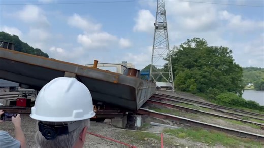 We launch a new spud barge. Spuds (steel extensions) are driven vertically into the riverbed as a means to resist currents. Spud barges are used in river construction and provide stable, elevated platforms for work. T See some of the barges we build: https://hl-fabrication.com/barge-models/?utm_source=Facebook&utm_campaign=Video&utm_medium=video-full-size #barges #fabrication #brownsvillePA #spud | Heartland Fabrication, LLC