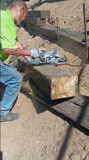 Skill saw cutting railroad tie.