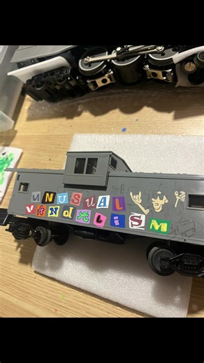 Caboose on the loose! #UnusualVandalism #TrimerTrains #2Cents #Caboose #BuzzLookAnAlien #Alien #Spaceship #Graffiti #OScale #Custom #Production #Colorful #Burner #Posca #Ransom #Letters #Structure #RockOn #Paint #Color #Trimer