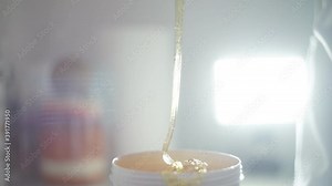 Depilation master woman scoop up the sugar paste right before the procedure of epilation