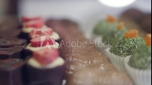 Rows of various sweets in the store, with a blur in the background. HD, 1920x1080, slow motion