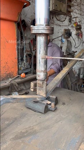 The metal part is being bent using a hydraulic press for industrial work #hard work