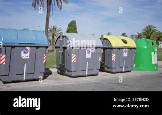 Blurred line of outdoor garbage containers and recycling bins, defocused street background with palm trees and pavement; backplate copyspace calm Stock Video Footage - Alamy