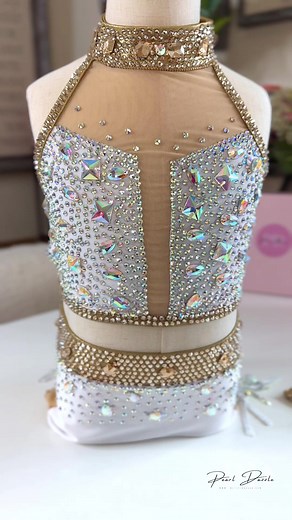 Introducing “Gilded Elegance,” a stunning jazz dance costume from Pearl Dazzle. ✨ This white and gold ensemble, with a simple cut and comfortable 2-piece design, exudes sophistication. Share your dance journey with #GildedElegance, #JazzDanceStyle, and #PearlDazzleDesigns for a touch of elegance on and off the stage! 💃🌟 #DanceCostume #JazzFashion #DanceElegance #pearldazzle #jazzdancecostume | Pearl Dazzle Dance Costumes